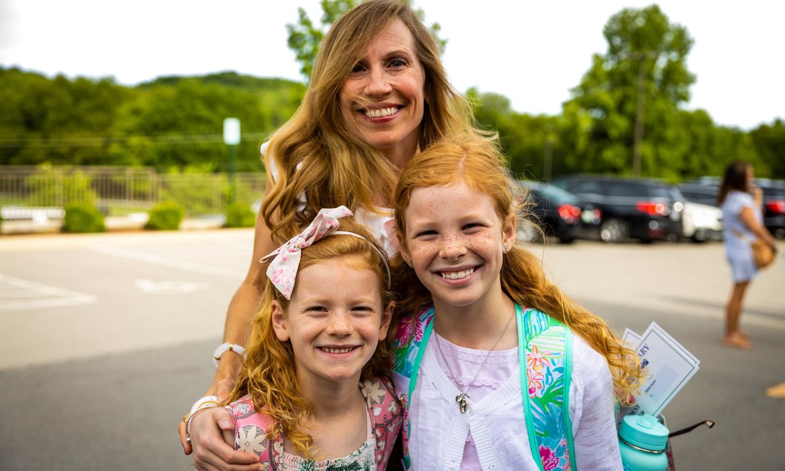 Mother and students smile